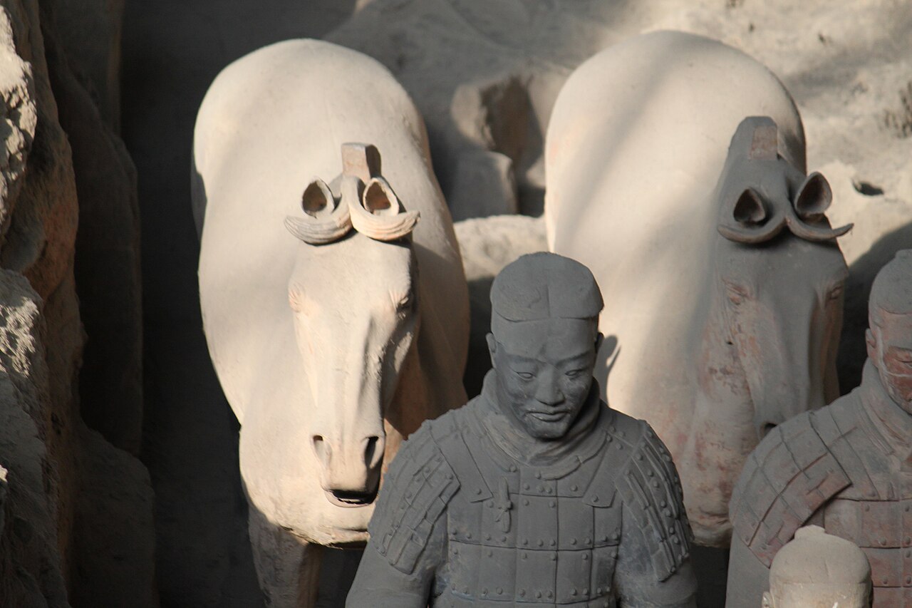 Rows of life-sized terracotta warriors standing in excavated Pit 1 at the tomb of Qin Shi Huang