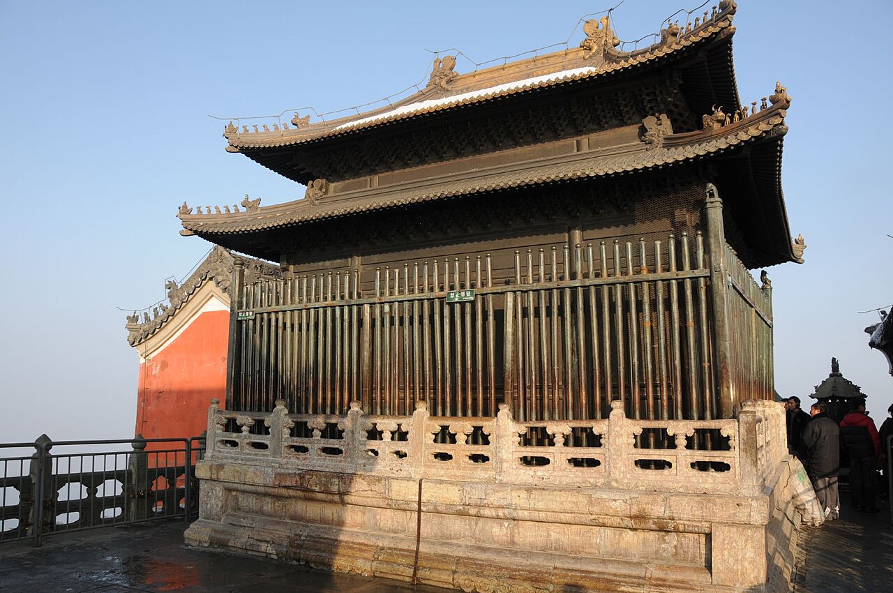 Ancient temple buildings of the Wudang Mountains rising above forested peaks